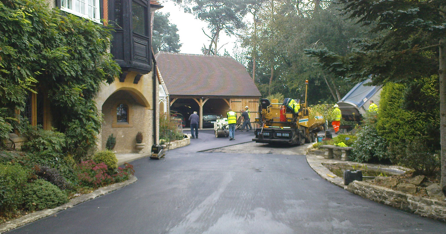 A tarmac driveway being laid by machine in Beenham