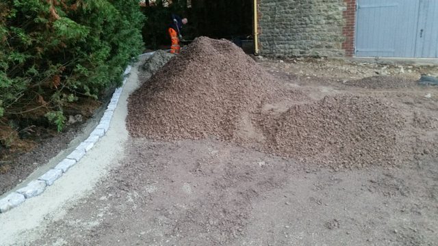 Aggregate delivered beside curved stone edging