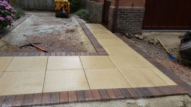 Paving slabs with a contrasting concrete paver block border