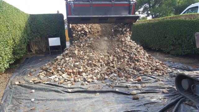 Tipper unloading crushed material for a driveway base